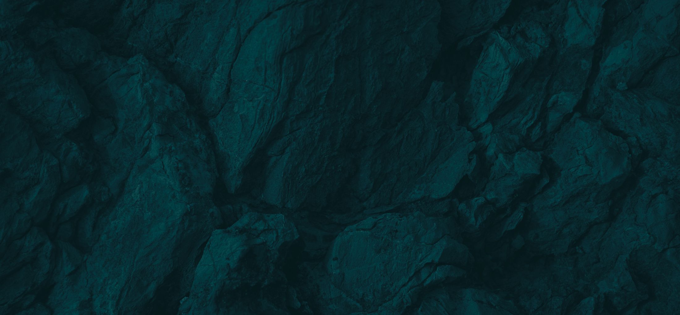 Textured dark teal rock background.