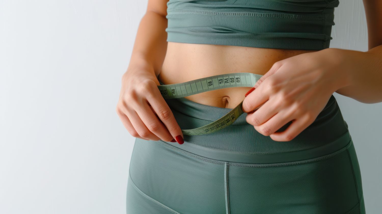 Measuring waist with a tape measure.