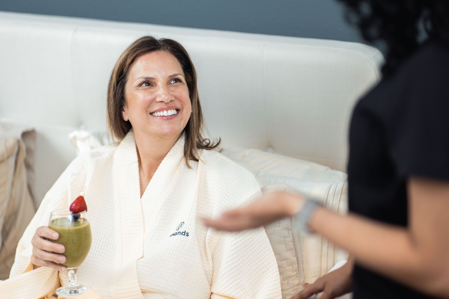 Smiling healthcare professional in scrubs with stethoscope.