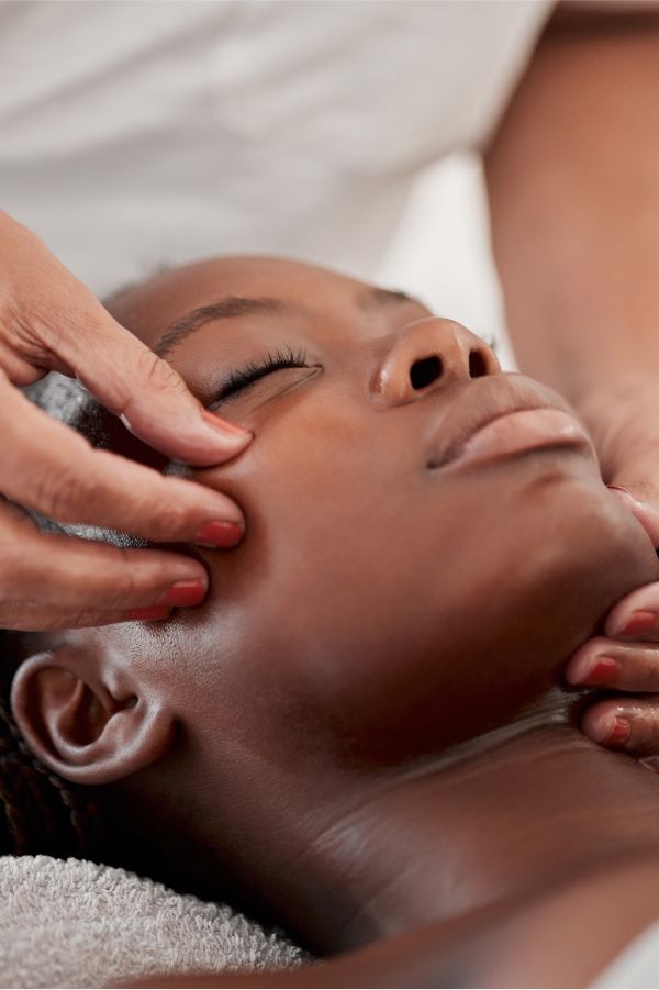 Person receiving a back massage therapy session.