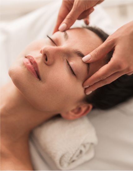 Facial massage relaxing woman in spa setting