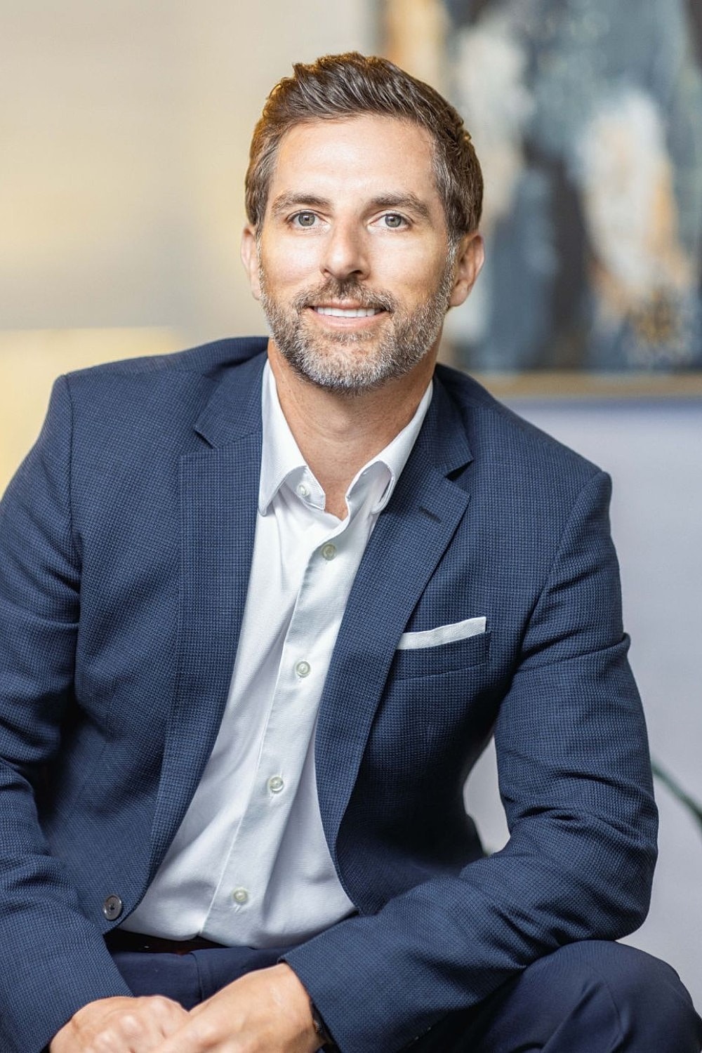 Man in suit smiling for portrait photo.