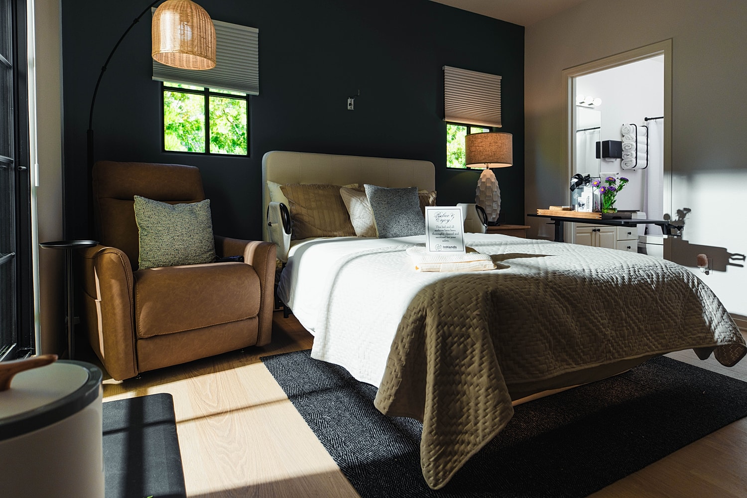 Modern bedroom with cozy seating and natural light.