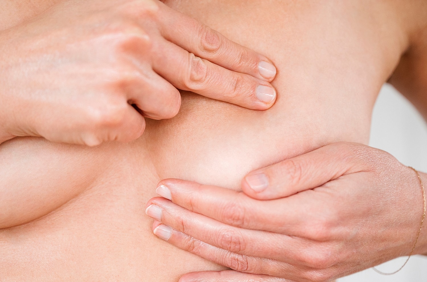 Self-breast examination technique demonstration.