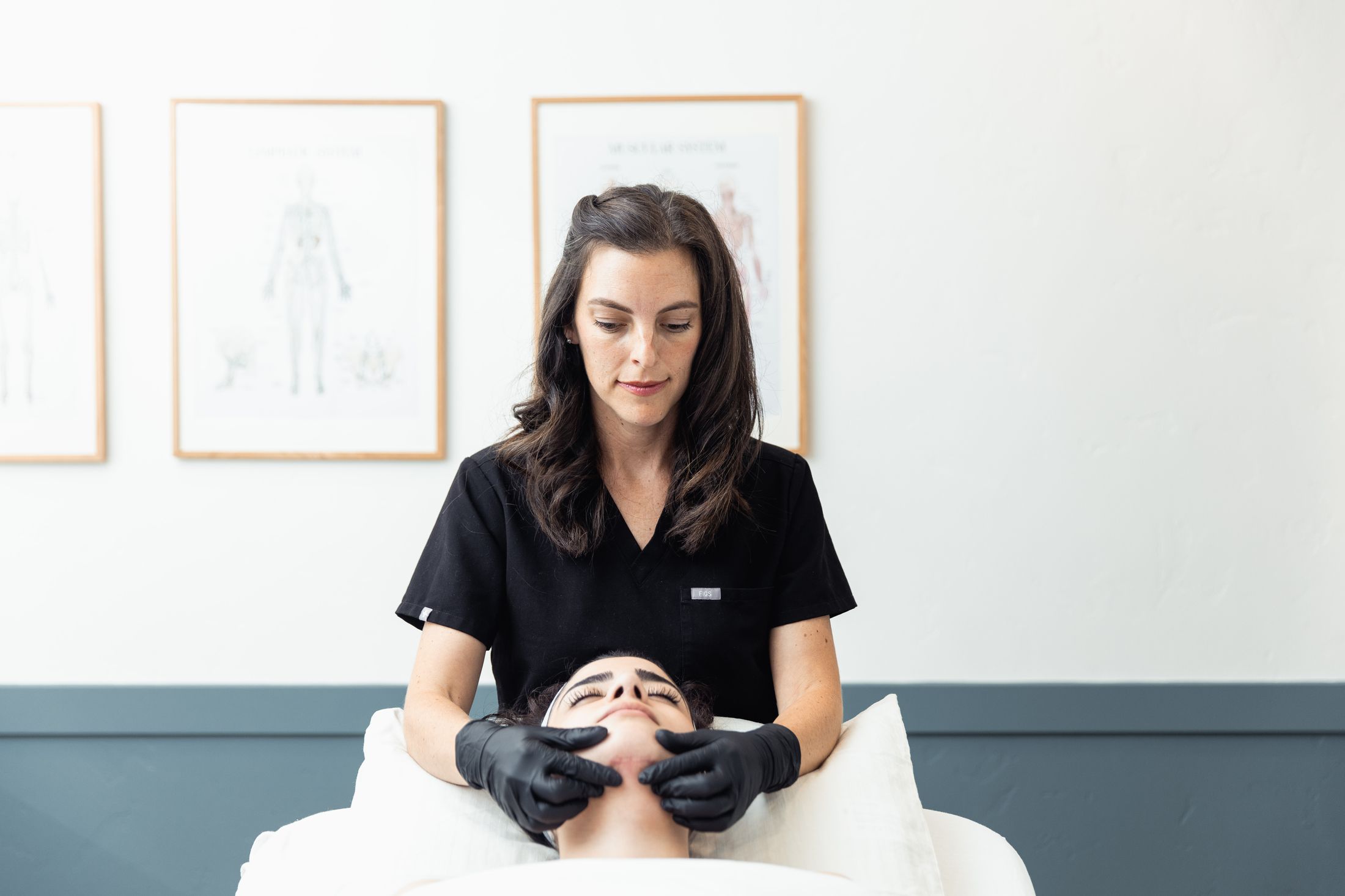 Skincare professional performing Lymphatic Therapy on client.