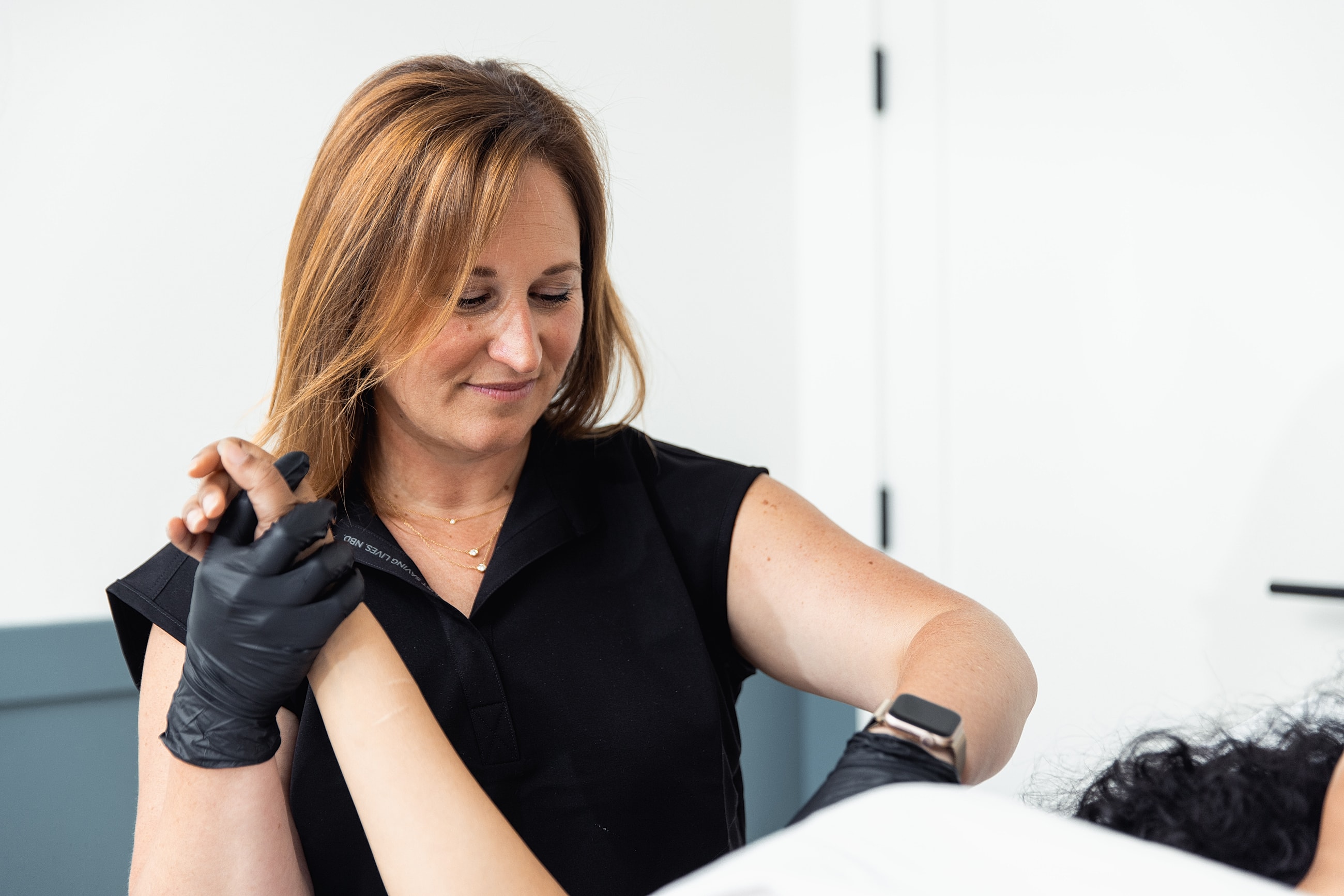 Professional applying treatment in a clinical setting.