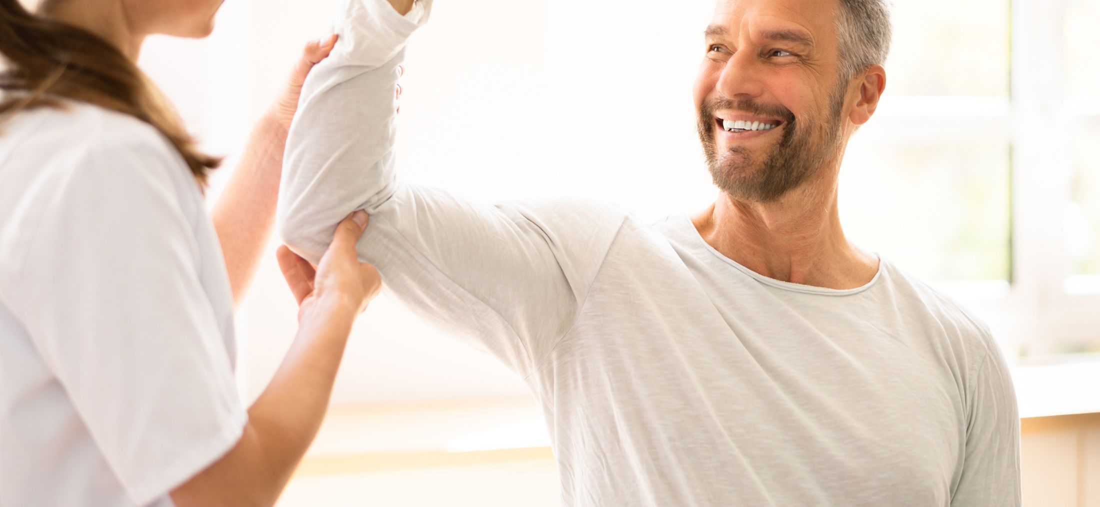 Physical therapy session with a smiling patient.
